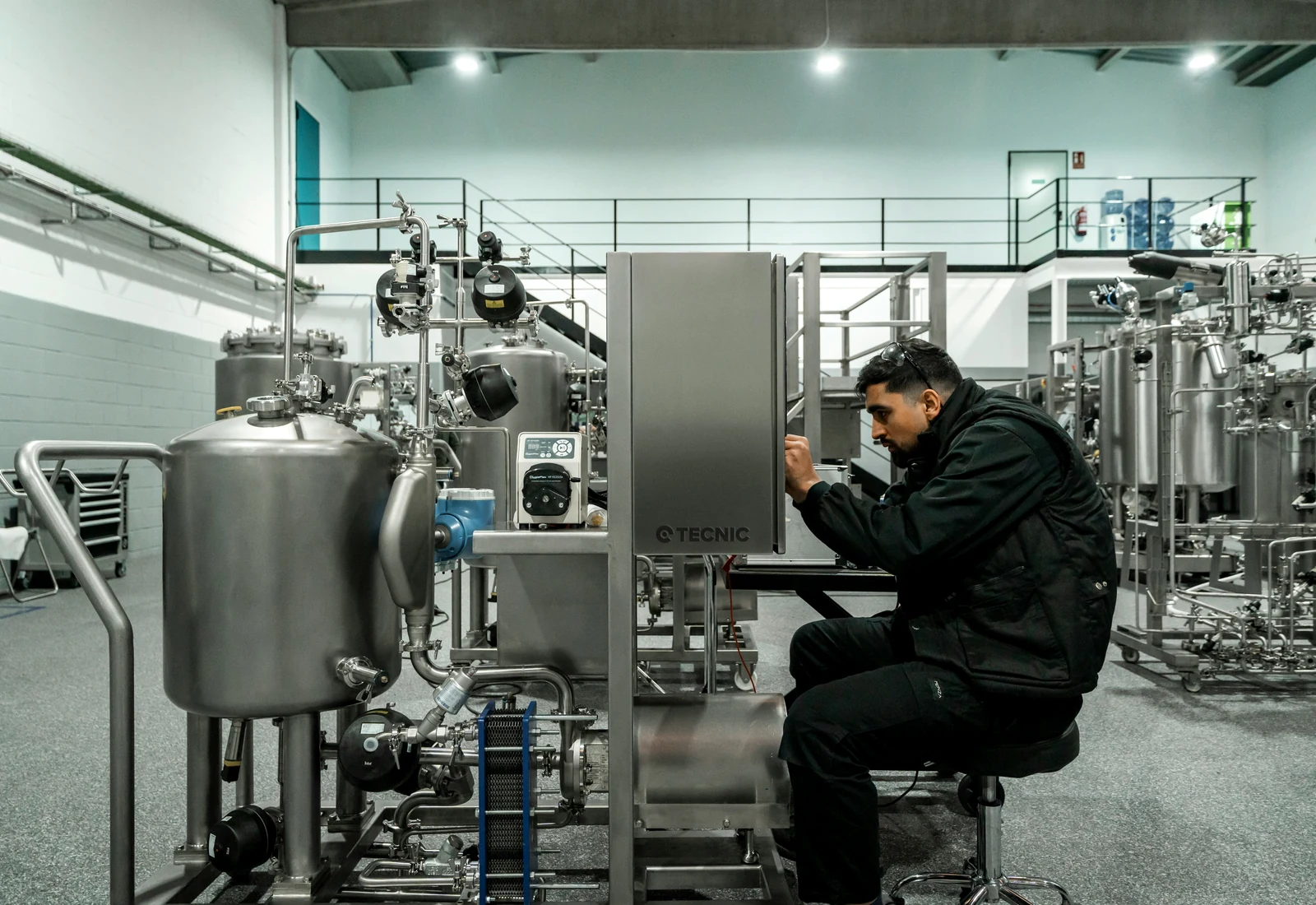 Engineer working on industrial processing equipment in a modern plant